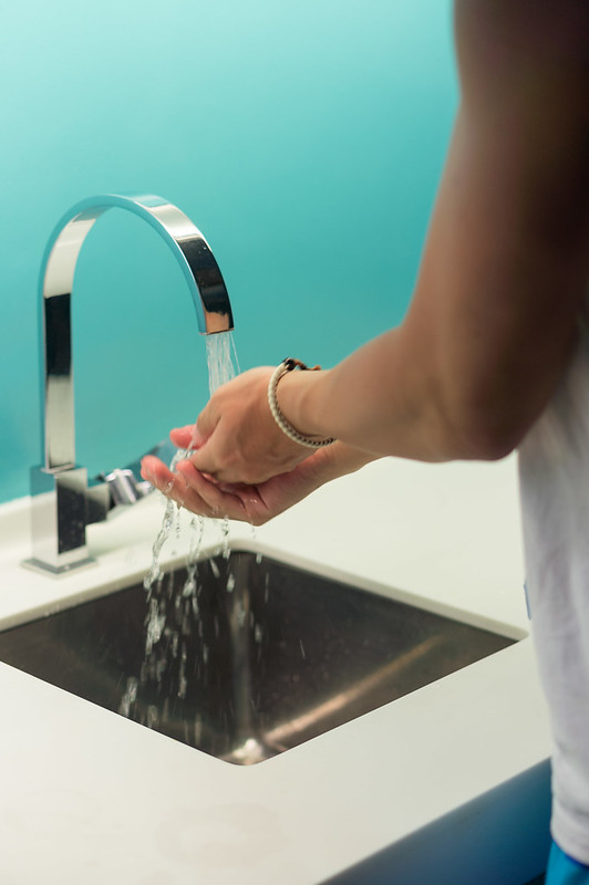 Person washing hands.